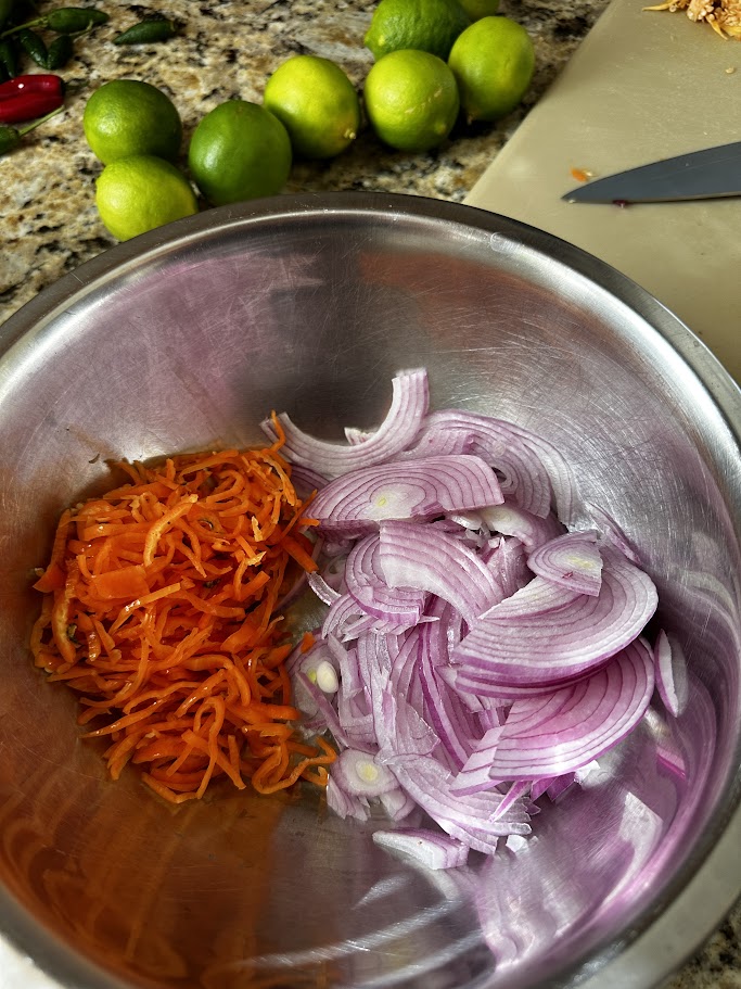 cut up habanero peppers and red onions in a bowl.