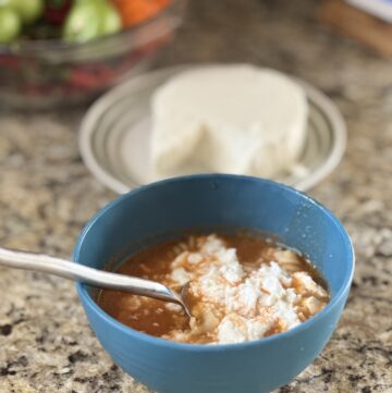 bowl of sopa de fideo garnished with queso fresco