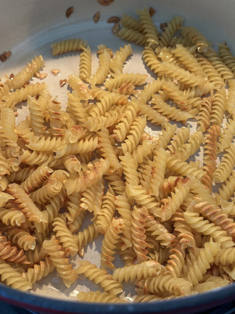 noodles in a pot being toasted to golden brown