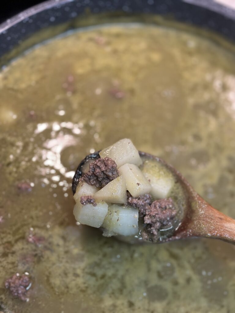 picadillo verde in a wooden spoon close up