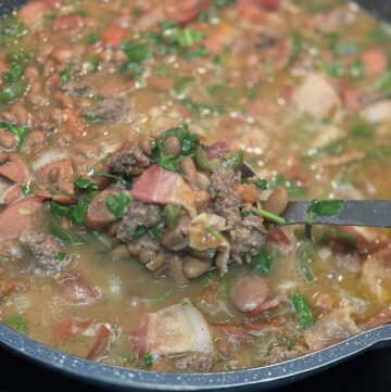 Finished product of fijoles charros in a pot to show ingredients.