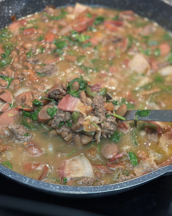 Finished product of fijoles charros in a pot to show ingredients.