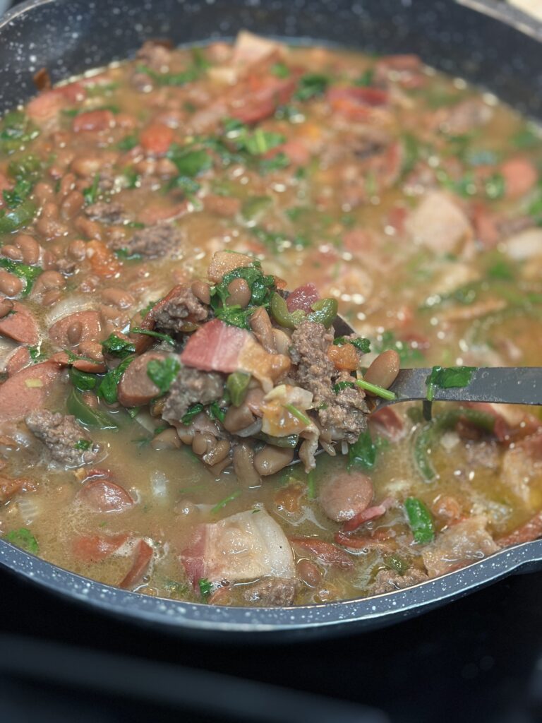 Finished product of fijoles charros in a pot to show ingredients.
